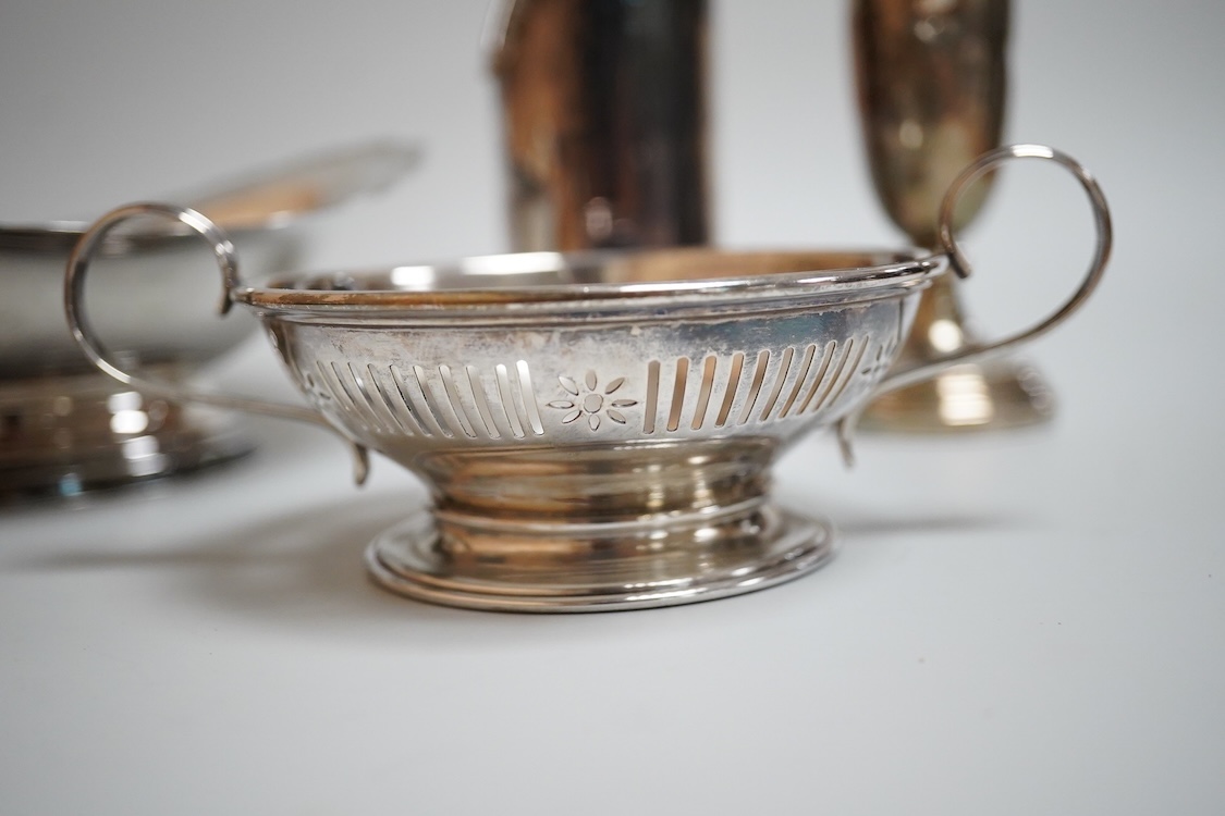 A modern silver oval pedestal sweetmeat bowl, by Mappin & Webb, Birmingham, 1987, 15.8cm, together with a small silver bottle holder, a silver mounted vase and a sterling two handled nut dish.